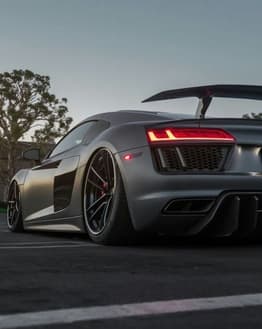 Audi-inspired Apple Watch face featuring a sleek sports car rear view with bold taillights