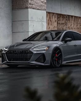 Audi RS7 parked in an urban setting with a modern and sleek design, featured on a watch face