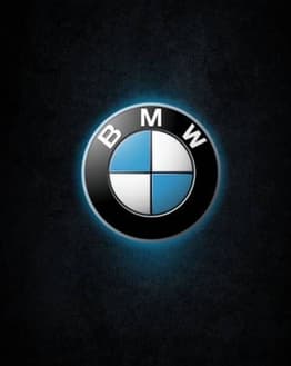 BMW logo glowing on a dark textured background, featured on a watch face