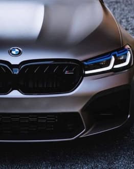 Close-up of BMW M5 front grille and LED headlights, featured on a watch face