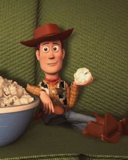 Illustration of Woody from Toy Story relaxing on a green couch with a bowl of popcorn, featured on a watch face.
