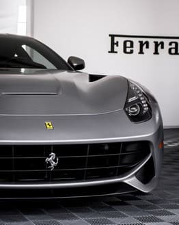 Front view of a silver Ferrari F12 Berlinetta with its iconic grille and sleek design, featured on a watch face.