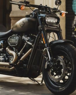 Close-up of a Harley-Davidson Fat Bob motorcycle with a sleek black finish, featuring a bold and powerful design, displayed on a watch face.
