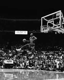 Black-and-white image of Michael Jordan mid-air during his iconic slam dunk, displayed on a watch face.