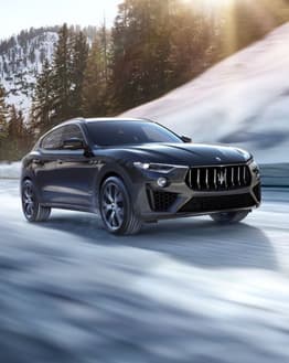 Maserati Levante SUV driving on a snowy mountain road, featured on a luxury watch face.