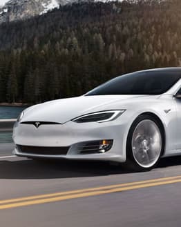 Tesla Scenic Drive watch face with a Tesla Model S driving through a forested road, paired with activity stats