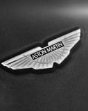 Aston Martin-inspired Apple Watch face featuring the iconic silver wings emblem on a black background