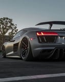 Audi-inspired Apple Watch face featuring a sleek sports car rear view with bold taillights