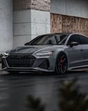 Audi RS7 parked in an urban setting with a modern and sleek design, featured on a watch face