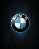 BMW logo glowing on a dark textured background, featured on a watch face