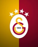 The Galatasaray crest with yellow and red colors, the year 1905, and four stars, set against a yellow and red split background, featured on a watch face.
