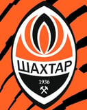 Shakhtar Donetsk football club crest with orange and black tiger stripes in the background, featured on a watch face