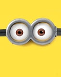 Close-up of Minions goggles with two brown eyes, set against a bright yellow background, featured on a watch face.