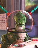 Illustration of Rex the green dinosaur wearing a space-themed helmet, featured on a watch face.