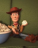 Illustration of Woody from Toy Story relaxing on a green couch with a bowl of popcorn, featured on a watch face.