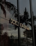 Dolce & Gabbana-inspired Apple Watch face featuring the iconic storefront with palm trees and sunset reflections