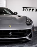 Front view of a silver Ferrari F12 Berlinetta with its iconic grille and sleek design, featured on a watch face.