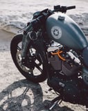 Close-up of a custom vintage motorcycle with a sleek design, displayed on a watch face.