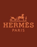 Hermès Paris-inspired Apple Watch face with a horse-drawn carriage logo on a brown background