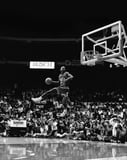 Black-and-white image of Michael Jordan mid-air during his iconic slam dunk, displayed on a watch face.