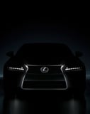 Silhouette of a Lexus car with illuminated headlights in a dark background, designed for a watch face.