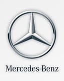 Mercedes-Benz logo with the three-pointed star emblem and brand name on a clean white background, featured on a watch face.