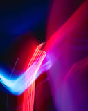 Abstract neon light trails in red, blue, and purple, creating a futuristic watch face design.