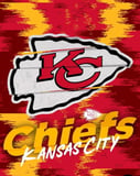Kansas City Chiefs logo featuring a red "KC" inside a white arrowhead with a red and gold textured background, displayed on a watch face.