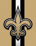 New Orleans Saints logo with a bold gold fleur-de-lis centered on a black, white, and gold background, displayed on a watch face.