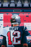 Football-themed watch face with a stadium backdrop, championship banners, and a tribute to legendary achievements.