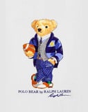 Illustration of the Polo Bear dressed in a varsity-style striped blazer, sweater vest, and pinstripe trousers, holding a football, featured on a watch face.
