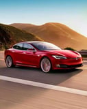 Tesla Model S in red cruising along sunlit mountain roads, perfect for a stylish and eco-conscious watch face.