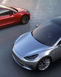 A Tesla Duo watch face featuring the red Model S and silver Model 3 parked side-by-side, highlighting sleek design and automotive innovation